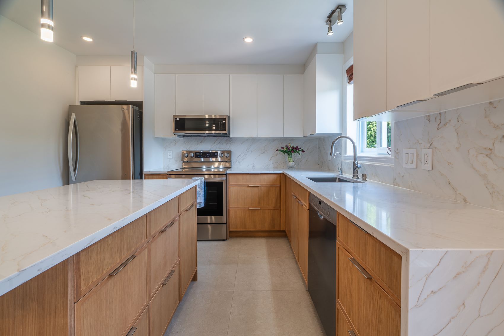 Kitchen interior with marble backsplash and waterfall island