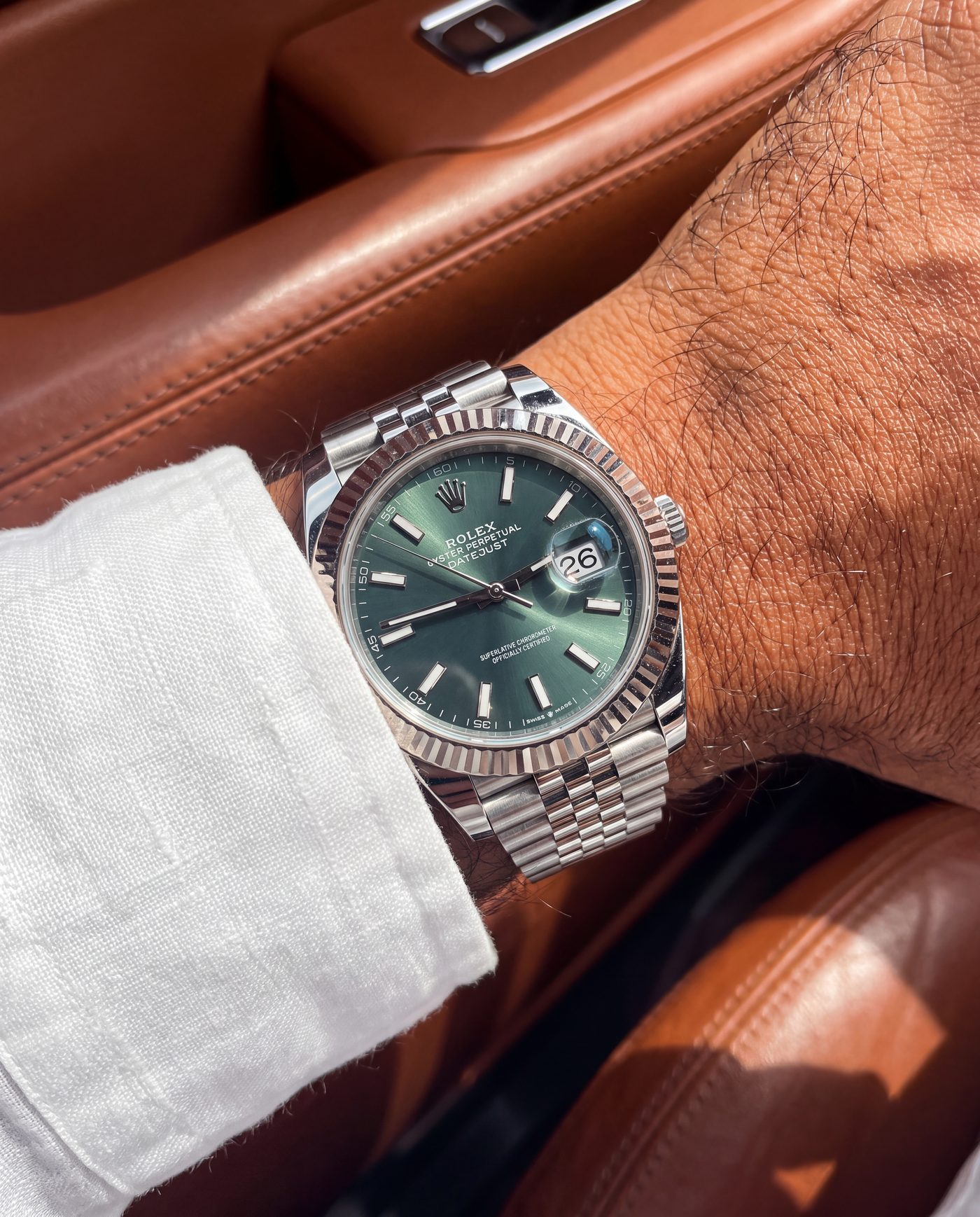 Rolex Datejust with green dial and fluted bezel, worn